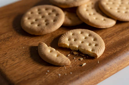 Cookies and broken cookies placed on a cutting board.の写真素材