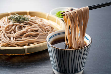 Zaru-soba placed on a black background. Soba noodles dipped in noodle soup. Zaru soba is a traditional Japanese food.の写真素材