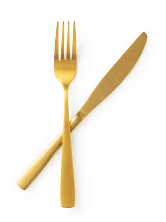 Golden knives and forks set against a white background. Gold cutlery. Beautiful gold cutlery. View...