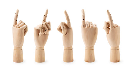 Wooden mannequin hand pointing against white background. Different angles. Gestures.の写真素材