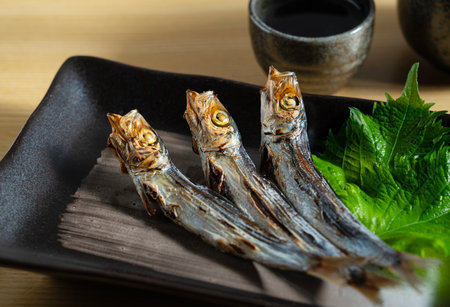 Grilled urume sardine placed on the table. A side dish of sake. Japanese food image.の写真素材