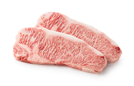 Fresh raw beef steaks set against a white background. Wagyu beef steak.の写真素材
