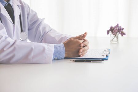 Doctor hand on clipboardの写真素材