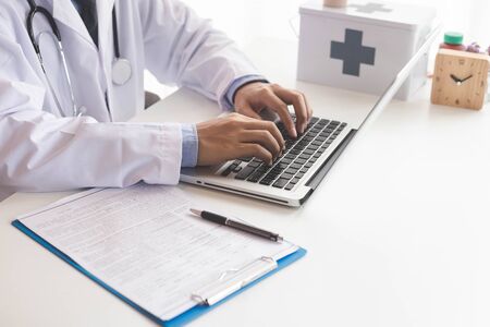 Doctor working on his notebook.