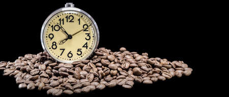 Scattered coffee beans, classic alarm clock. Morning coffee day start. Concept for advertising. Time to drink coffeeの写真素材