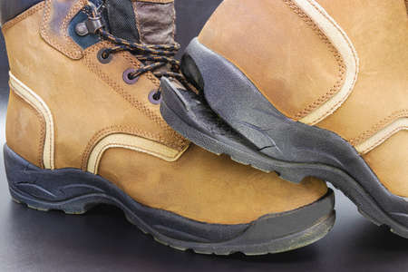 Torn men's leather shoes. Torn shoe sole. Shoe repair. Close-upの写真素材