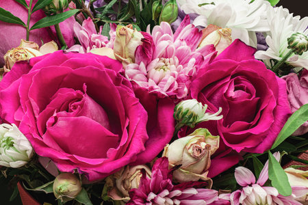 floral background, summer season concept. a close-up bouquet of flowers with a blurred background, as a natural background for the designer. roses, chrysanthemums. partial sharpness, banner.の写真素材
