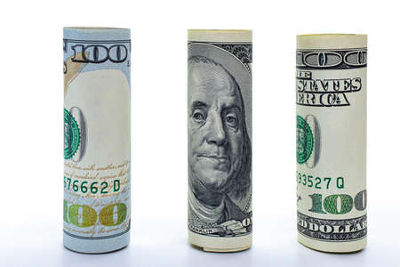 One hundred dollar banknote rolled into a tube. Close-up. Isolated white background. Concept for design.の写真素材