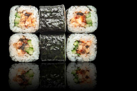 Seafood rolls - isolated black backgroundの写真素材