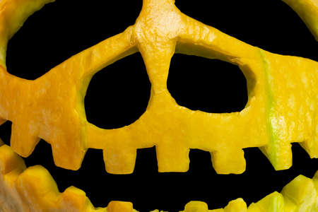 Pumpkin for halloween on black isolated background. Carved face on a pumpkin. Celebration. October 31. All Saints' Day. Close-up.の写真素材