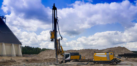 Hydraulic Drilling Rig. The device of bored piles with casing. Foundations and grounds. Drilling in the ground. Technologies.の写真素材