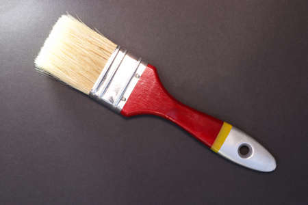 Paint brush. Surface painting. Work tool. Black gradient background. Copy space for text.