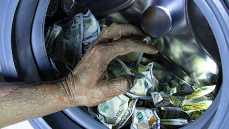 Money laundering. Corruption Concealment of taxes. Dollars in the drum of a washing machine and...