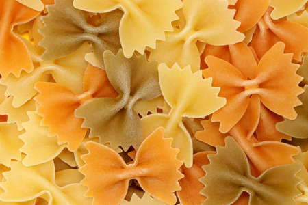 Background from multi-colored pasta. Natural product. Vegetarian. Close-up. Concept for food advertising.の写真素材