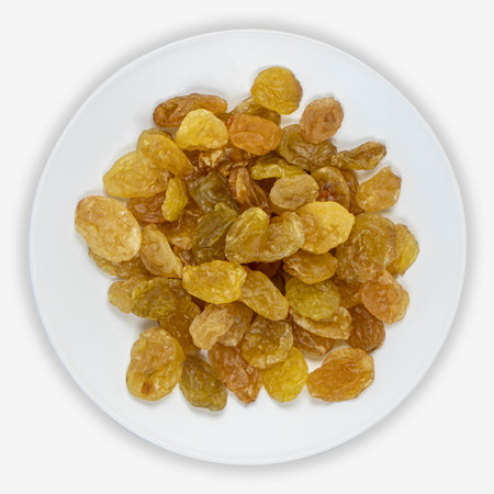 Raisins from green grapes on a white plate. Isolated background. View from above.の写真素材