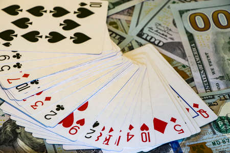 Deck of cards on the background of dollar bills