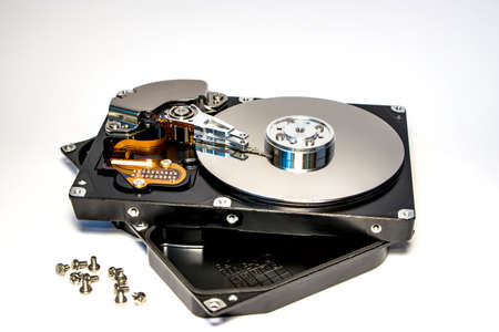 Disassembled hard drive from the computer, hdd with mirror effect. Opened hard drive from the computer hdd with mirror effects. Part of computer pc, laptopの写真素材