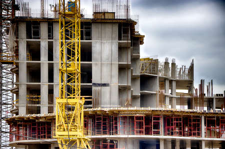 Construction. Tower crane. The process of building residential buildings.