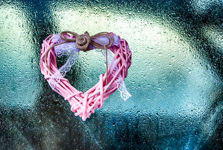 Heart on a frozen glass. Finger drawing. Hoarfrost and frost. A nice gift to your loved one. Concept...