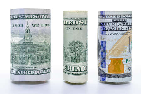 One hundred dollar banknote rolled into a tube. Close-up. Isolated white background. Concept for...