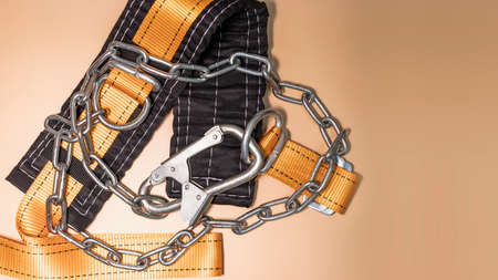 Safety belt for work at height with carabiner. Professional safety equipment for mountaineering and construction. Safety precautions. Close-upの写真素材