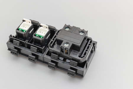 A block of electrical outlets and a network outlet on a gray background. Home electrician. Close-up. Full focus. copy spaceの写真素材