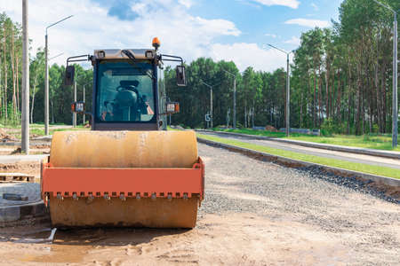 Heavy-duty vibratory roller for asphalt paving. Road construction. Construction of roads and urban...