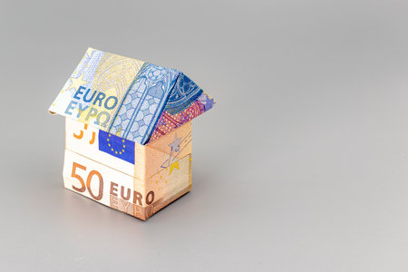 Purchase and sale of housing. Mortgage for the purchase of a house. Rental Property. House folded from euro banknotes. Origami. Close-up. Copy space. Housing in Europeの写真素材