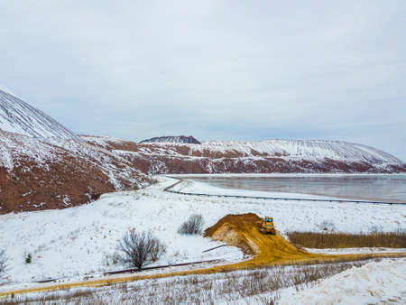 A waste heap or waste heap is a dump, an artificial embankment made of waste rock extracted during underground mining of mineral deposits. Winter landscape. Belarus. Soligorsk. Potassium saltの写真素材