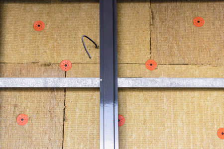 Power saving technology: plates of mineral wool on the side wall, between the metal profiles for attaching the ventilated facadeの写真素材