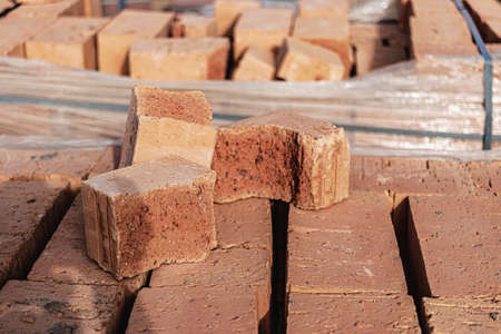 Bricks in pallets on a construction site. Construction Materials. Red brick for building a house