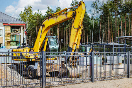 A heavy crawler excavator with a large bucket is getting ready for work. Heavy construction...