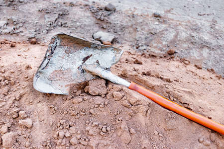 A shovel at a construction site on a pile of earth. Manual construction tool. Excavationの写真素材