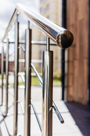 A ramp and metal railings at the entrance to the residential building for the convenience of disabled and elderly peopleの写真素材