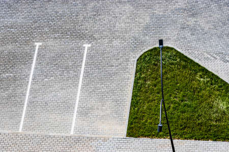 Empty parking in the courtyard of a house with white markings on paving stones or paving slabs. View...