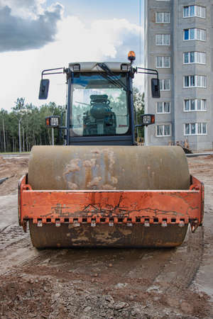 Heavy-duty vibratory roller for asphalt paving. Road construction. Construction of roads and urban...