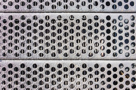 Perforated metal background. Grunge background of old iron with holes
