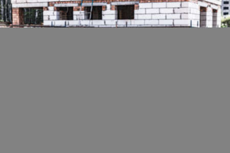 Storage of boards and building materials at the construction site. Preparation of material for building a house from aerated concreteの写真素材