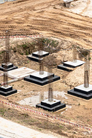 Monolithic reinforced concrete foundations for the construction of a residential building. Grillage at the construction site. Construction pit with foundationsの写真素材