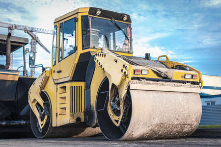 Heavy-duty vibratory roller for asphalt paving. Road construction. Construction of roads and urban...