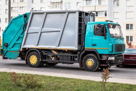 A garbage truck picks up garbage in a residential area. Separate collection and disposal of garbage....