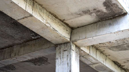 Old reinforced concrete floor with columns. Mold and mildew on an abandoned building structure....