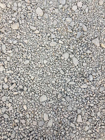 Stone background. gravel pebbles stone seamless texture, marble. dark background of crushed granite...