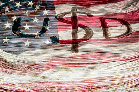 Symbol of the American currency on the background of the USA flag. Dollar symbol Hand-painted with a brush. Design concept for business and politics.の写真素材
