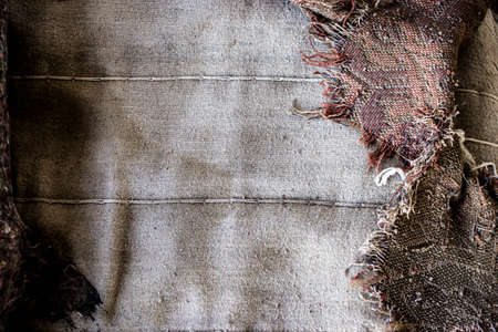 Old burlap and batting. Protruding threads. Conceptual background for design.