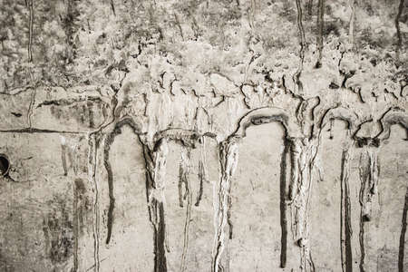 Old concrete wall with cement drips. Construction in progress. Conceptual background for construction.の写真素材