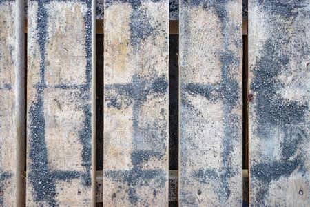 A pallet from paving slabs covered with concrete chips. Background of wood planks with fine concrete chipsの写真素材