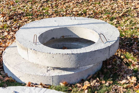 Reinforced concrete rings for wells and sewers at the construction site. Preparation of materials...