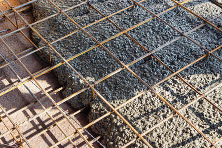 Pouring cement or concrete with a concrete mixer truck, construction site with a reinforced grillage...