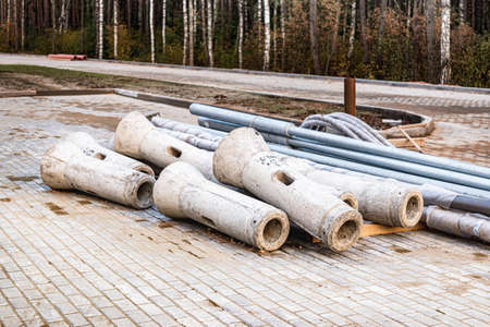 The lampposts prepared for installation and assembly are stacked at the construction site